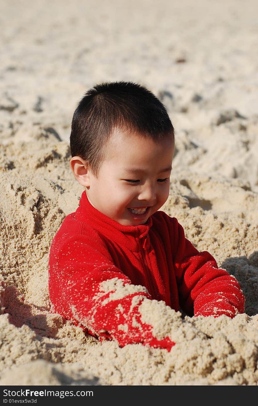 Young Boy Playing joyfully in sunny beach. Young Boy Playing joyfully in sunny beach