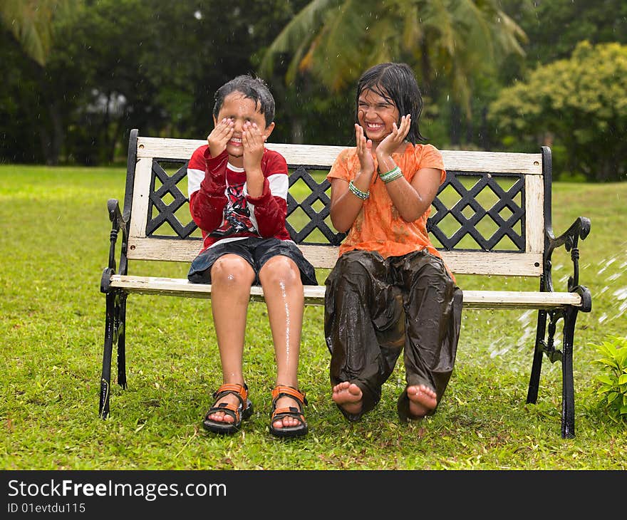 Asian origin kids playing in the rain. Asian origin kids playing in the rain