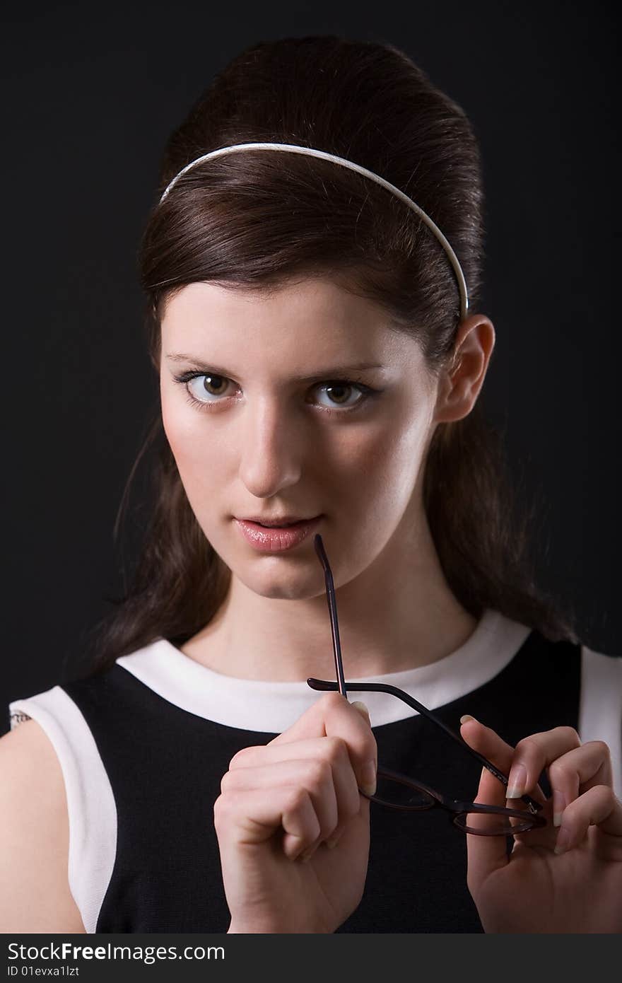 Portrait of a young woman holding glases. Portrait of a young woman holding glases.