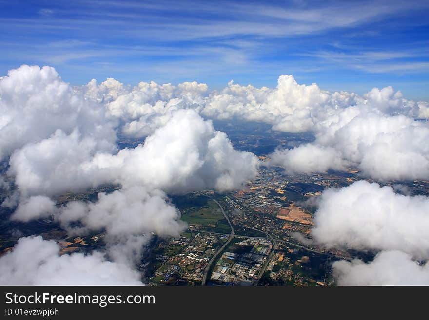 Aerial view of cloudscape over a cityscape.