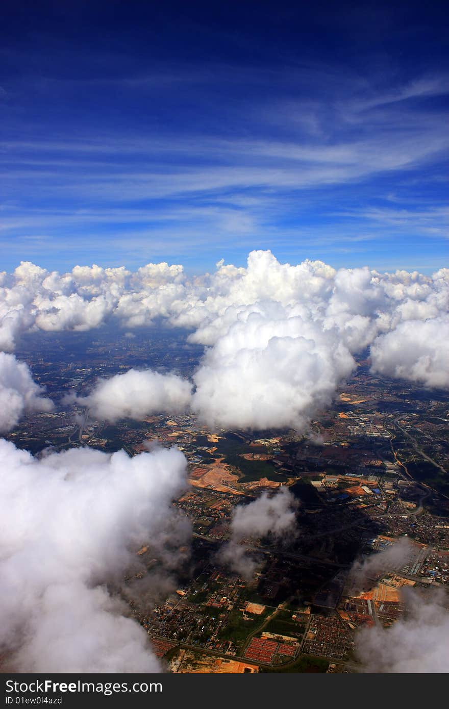 Aerial view of cloudscape over a cityscape.