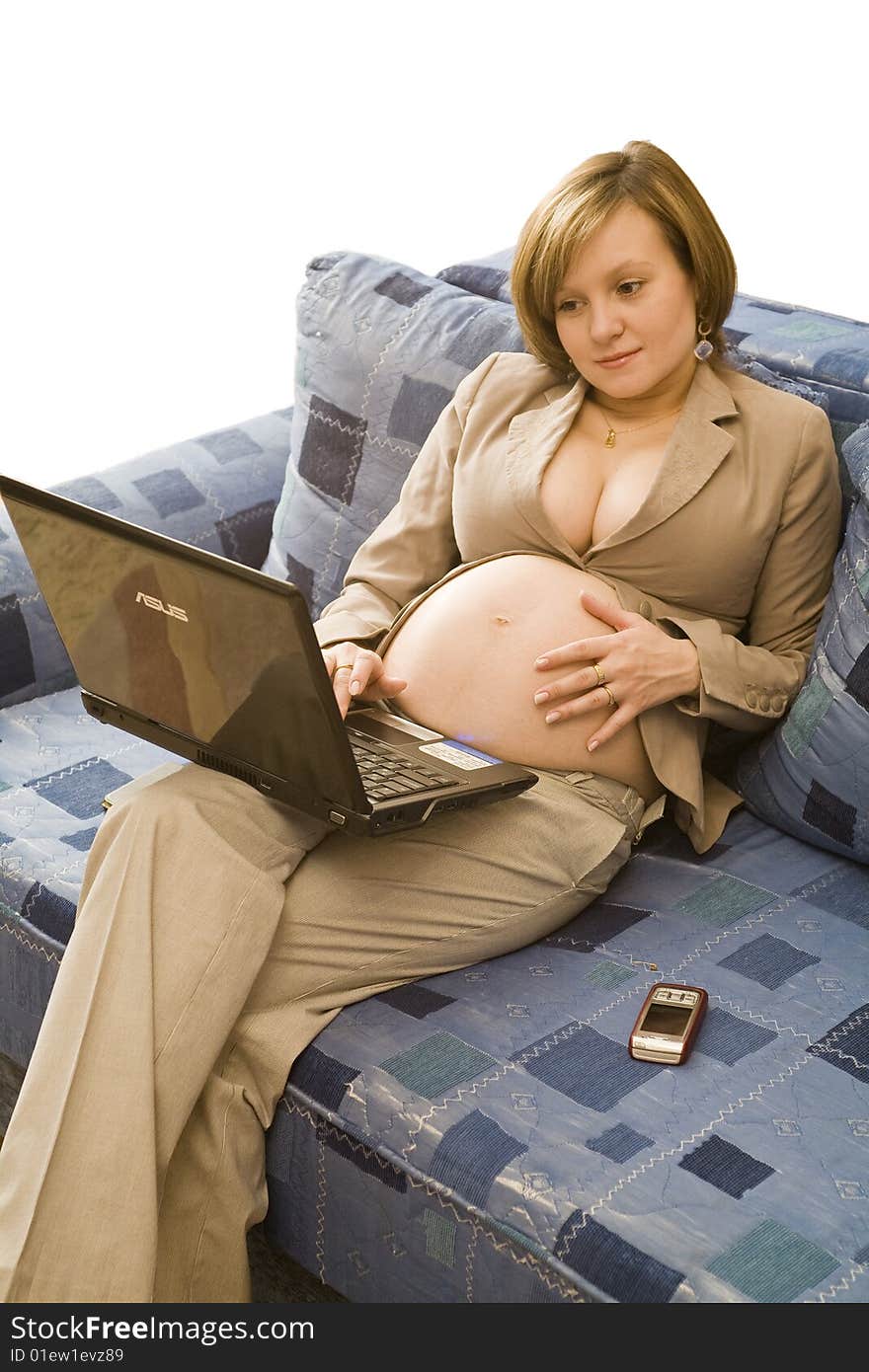 Young pregnancy woman worked at home with notebook and mobile phone. Young pregnancy woman worked at home with notebook and mobile phone