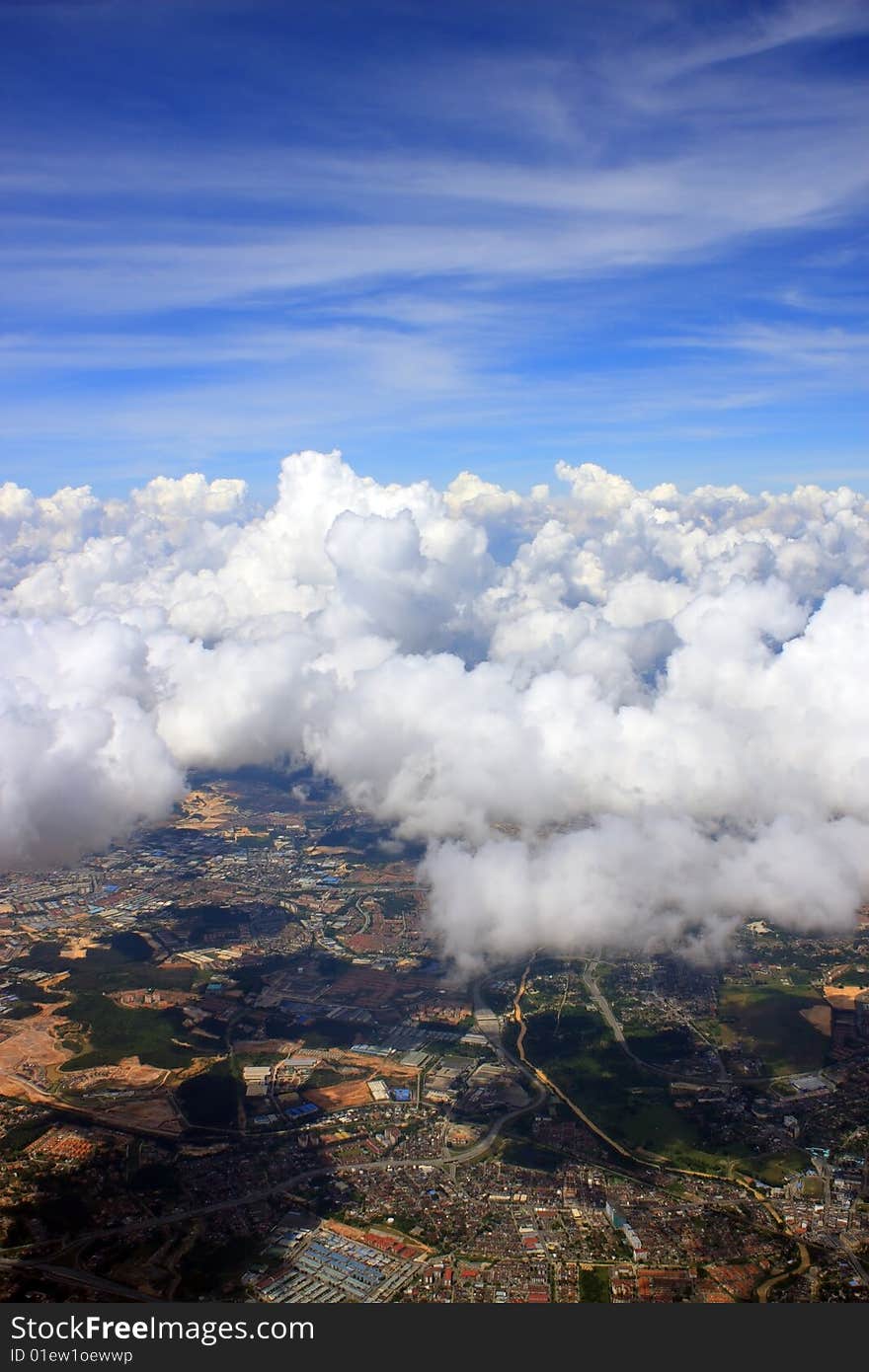 Aerial view of cloudscape over a cityscape.