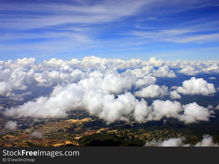 Aerial view of cloudscape over a cityscape.