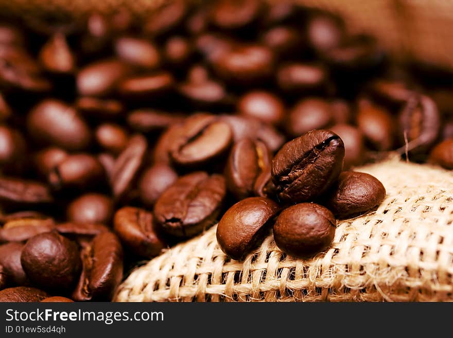 Inside burlap bag filled with coffee beans - selected focus. Inside burlap bag filled with coffee beans - selected focus