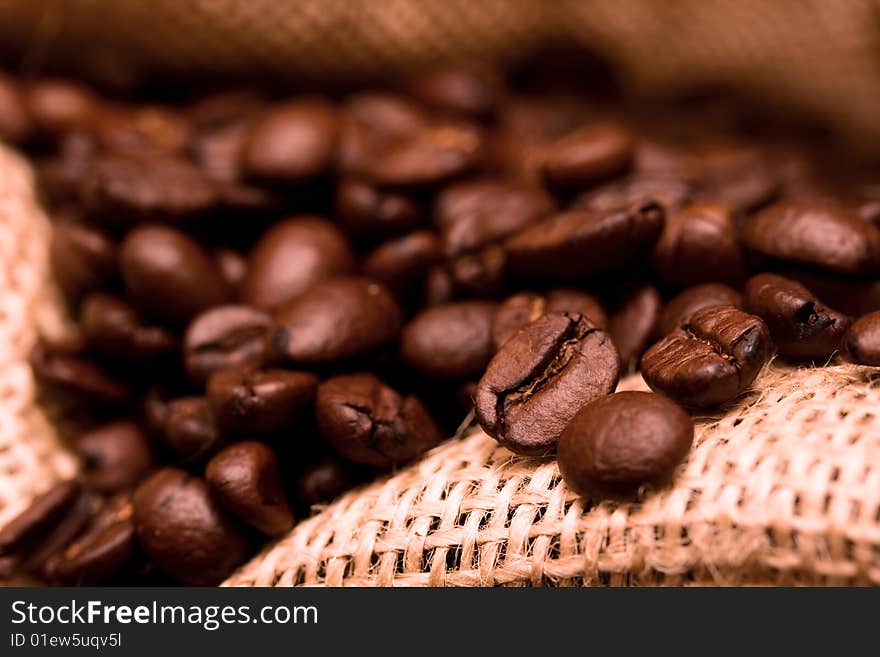 Inside burlap bag filled with coffee beans - selected focus. Inside burlap bag filled with coffee beans - selected focus