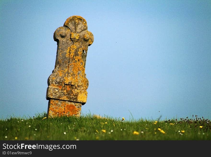 Ancient gravesite with unmarked gravestones from the 1600's in the middle of a meadow.