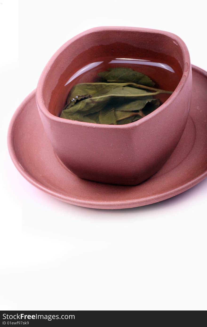 A cup of tea is on white background.
This is traditional Chinese tea.