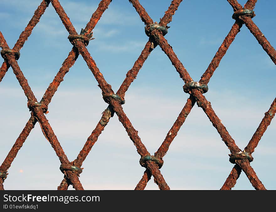 Rusty grates with blue sky on the background