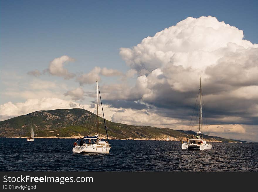 Yachts sailing near shore