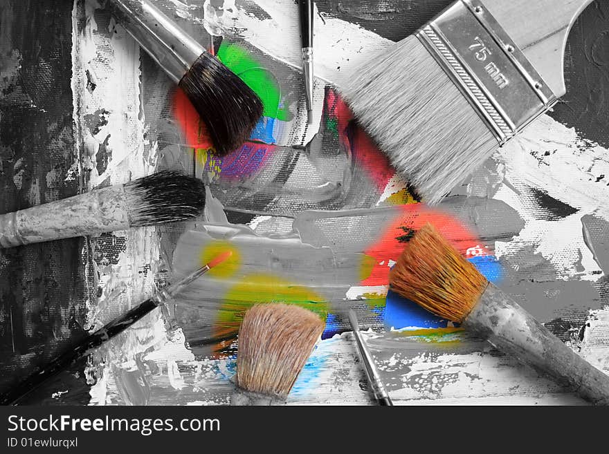 The image of an abstract picture and brushes of the artist laying on it. The image of an abstract picture and brushes of the artist laying on it.