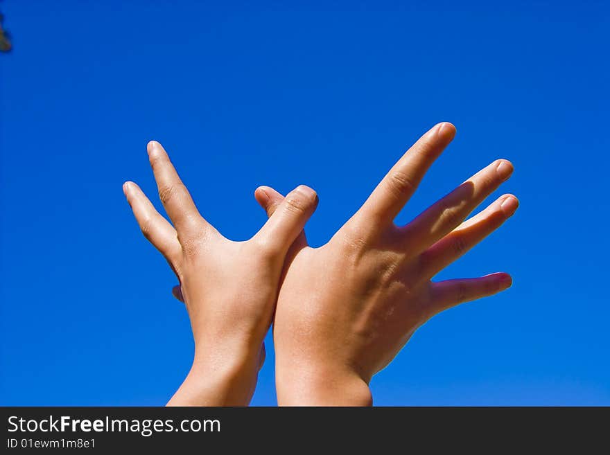 Heands reaching out over blue background. Heands reaching out over blue background