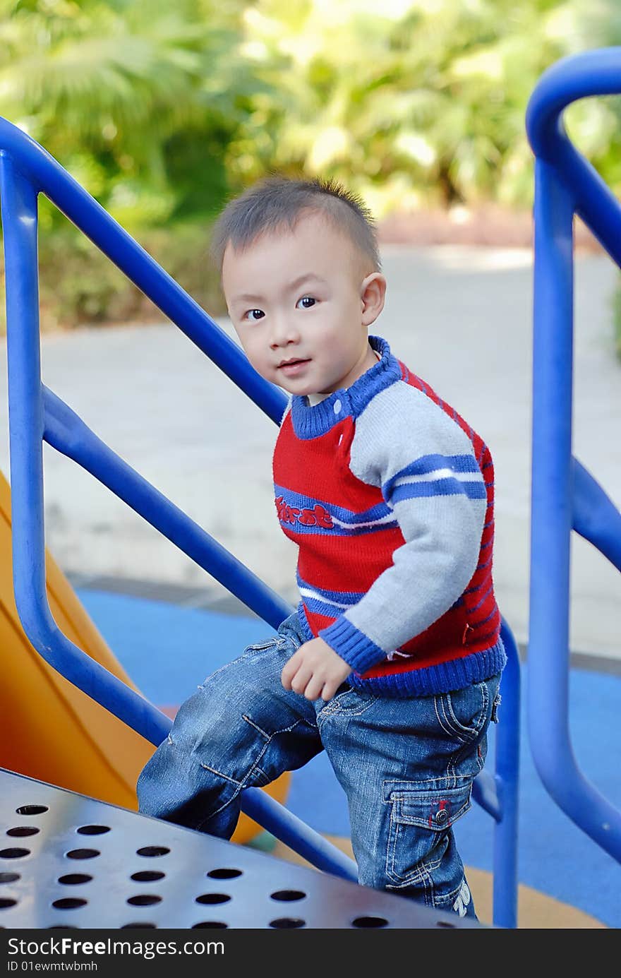 Bright picture of adorable chinese baby boy in the playground. Bright picture of adorable chinese baby boy in the playground
