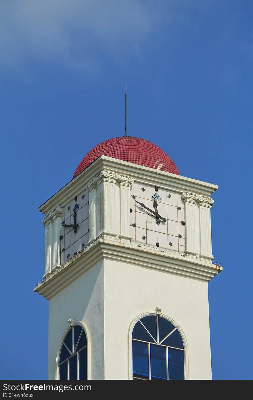 A clock tower with blue sky background. A clock tower with blue sky background