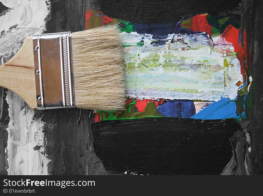 The image of an abstract picture and brushes of the artist laying on it. The image of an abstract picture and brushes of the artist laying on it.