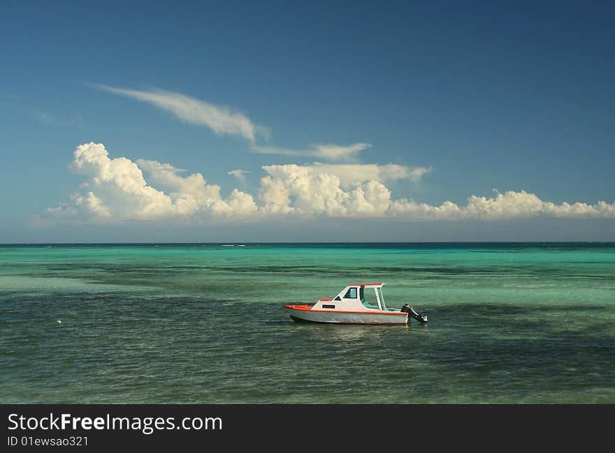 Boat rests in turquoise waters on the Yasawa Island chain. Boat rests in turquoise waters on the Yasawa Island chain