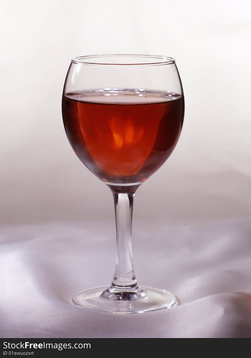 Glass of red wine on a white cloth