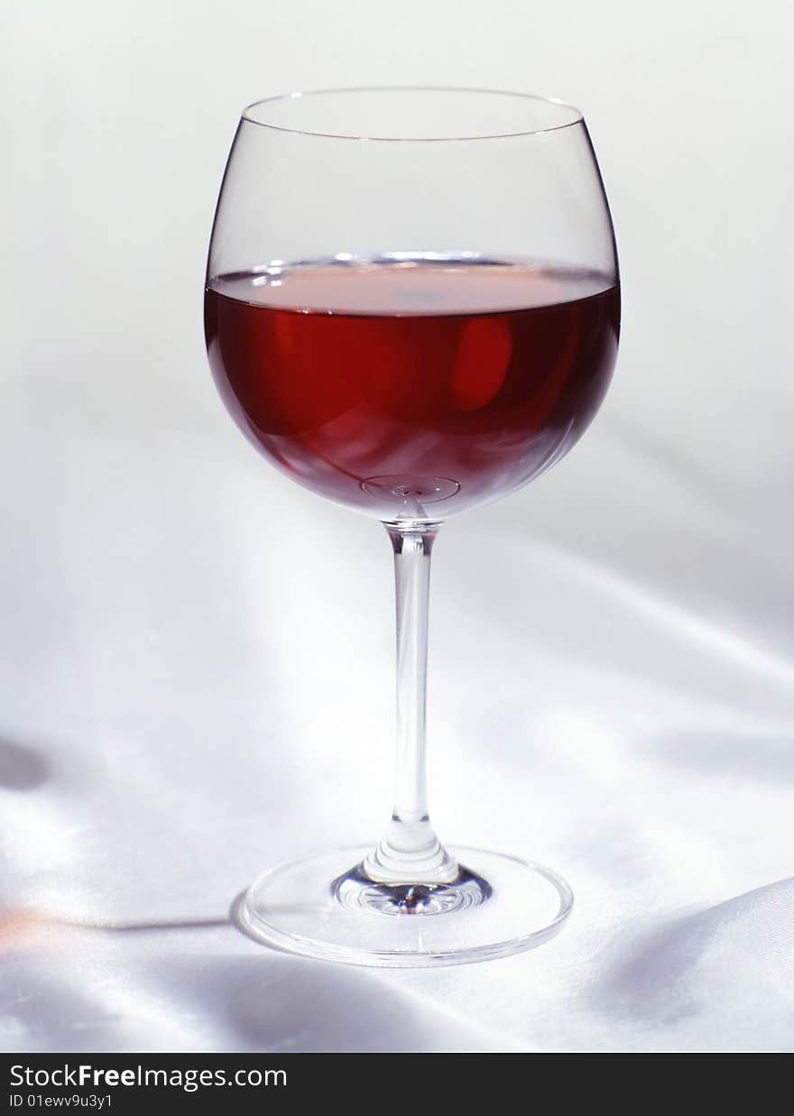 Glass of red wine on a white cloth