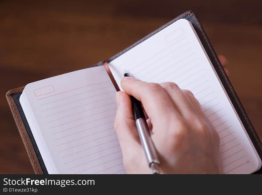 Female Hand Writes Notes In Notebook