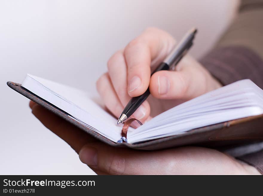 Female Hand Writes Notes In Notebook