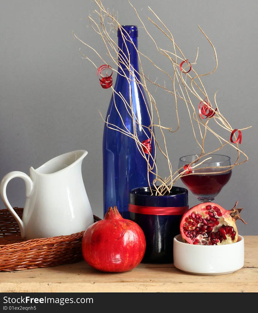 Still-life with pomegranate and dishes