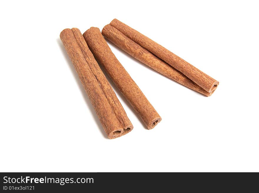 Three cinnamon sticks on white background.