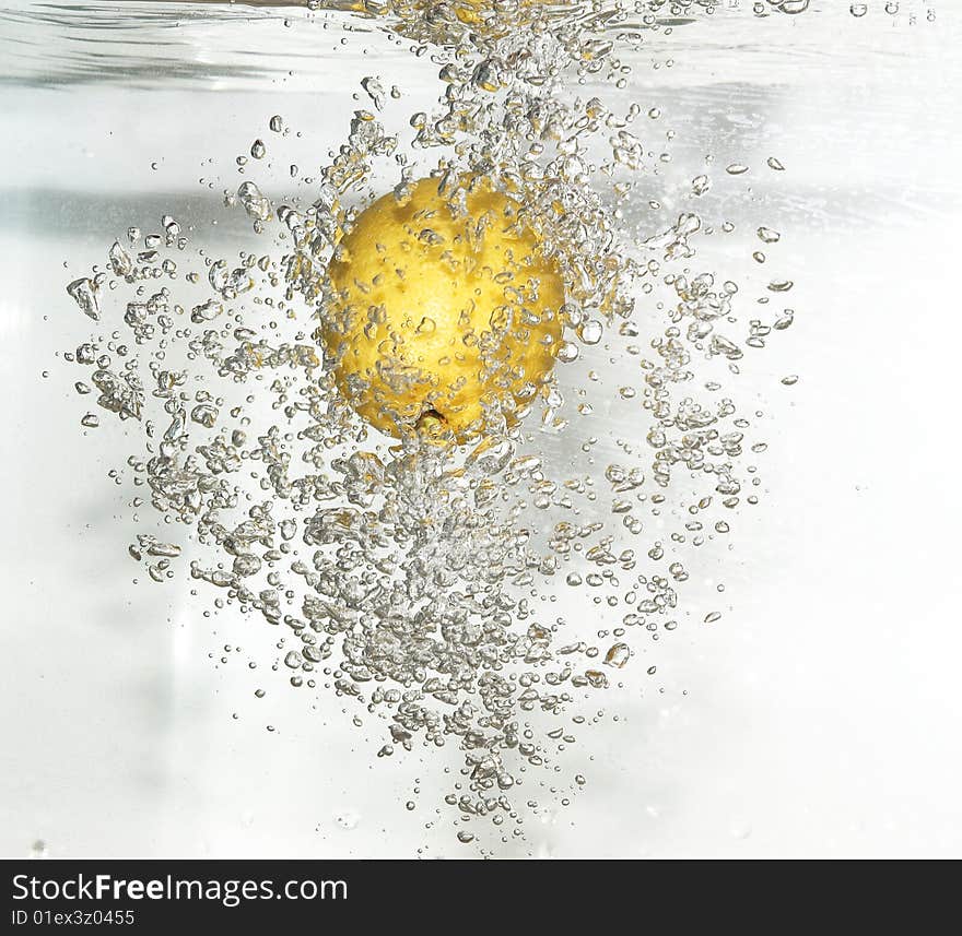 Lemon Is Dropped Into Fresh Water.