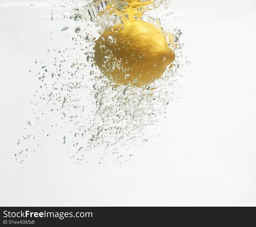 Lemon is dropped into clean and fresh water. Lemon is dropped into clean and fresh water.