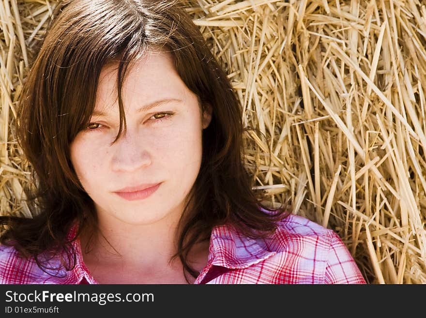 Young woman in haystack