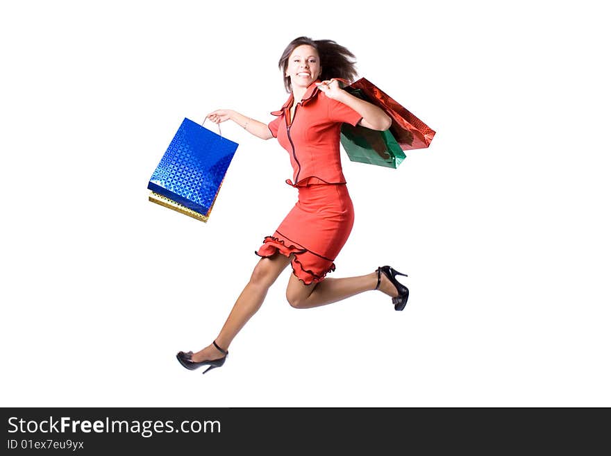 The young beautiful girl with purchases in colour packages during shopping on a white background