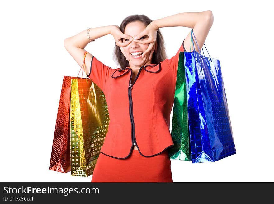 The young beautiful girl with purchases in colour packages during shopping on a white background