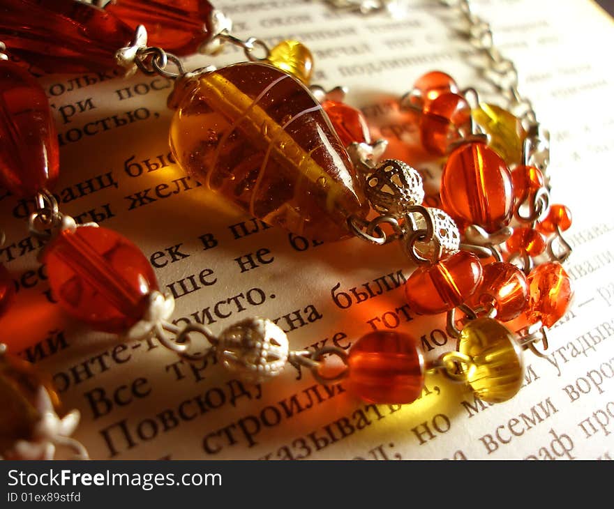 The red & yellow necklace on the book page. The red & yellow necklace on the book page