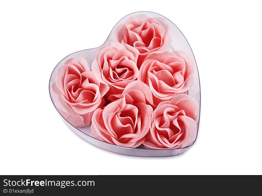 Pink roses in a heart shape, isolated on white background