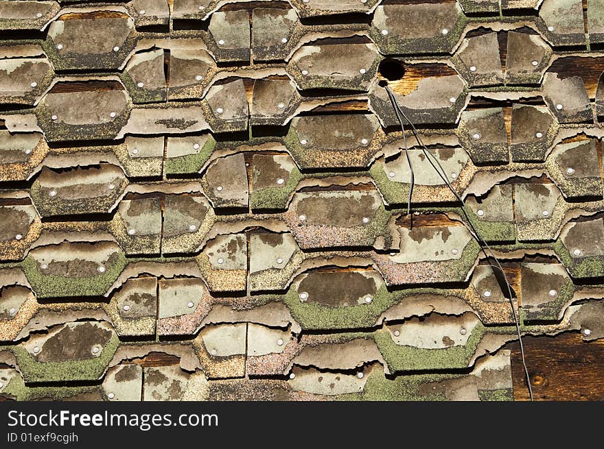 Abstract pattern of shingles used as siding on an exterior wall. Abstract pattern of shingles used as siding on an exterior wall