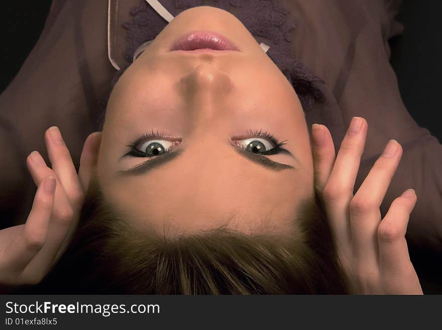 Beautiful young girl looking into the camera and touching her face. Beautiful young girl looking into the camera and touching her face