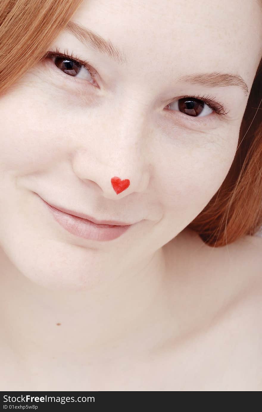 Young woman with heart on the nose