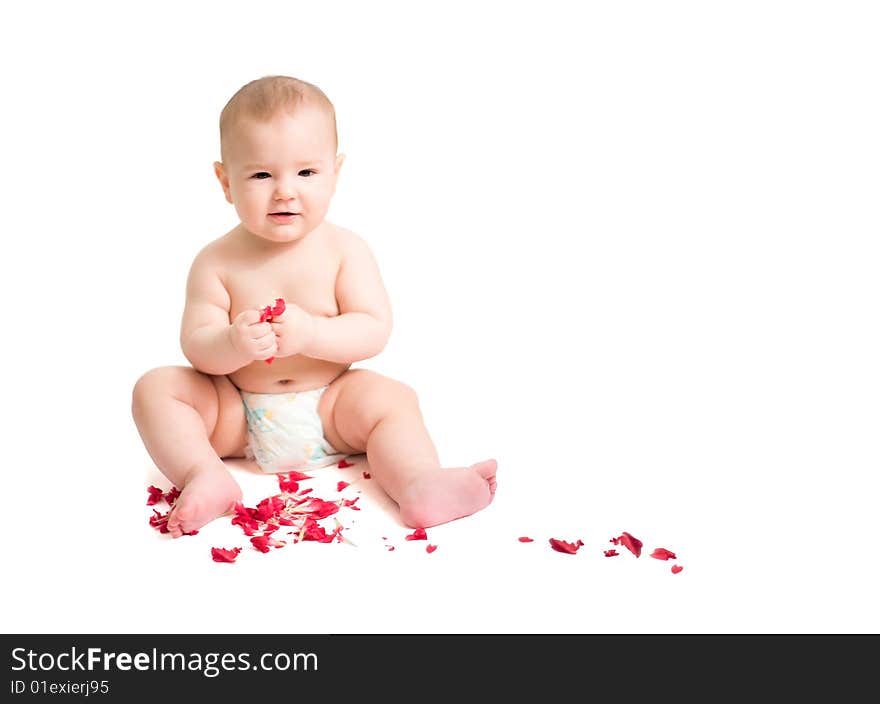 Baby playing with red petals