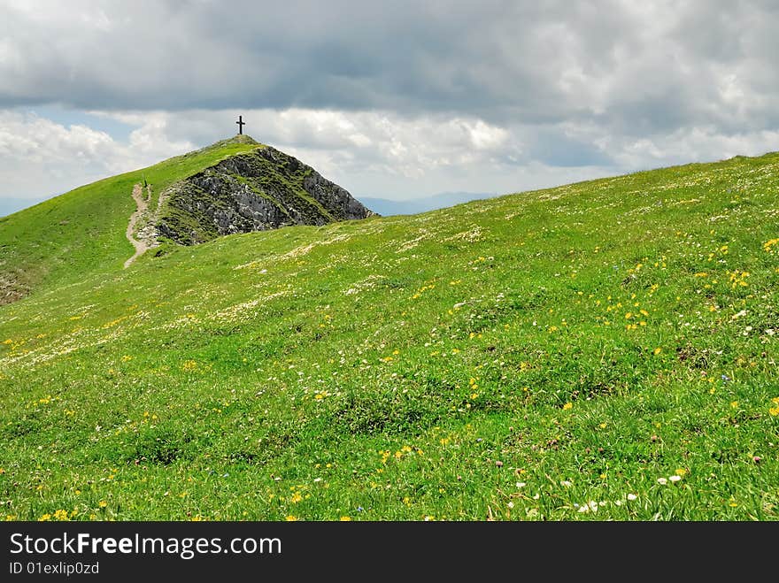 Mountain summit with flower plain and cloudscape. Mountain summit with flower plain and cloudscape