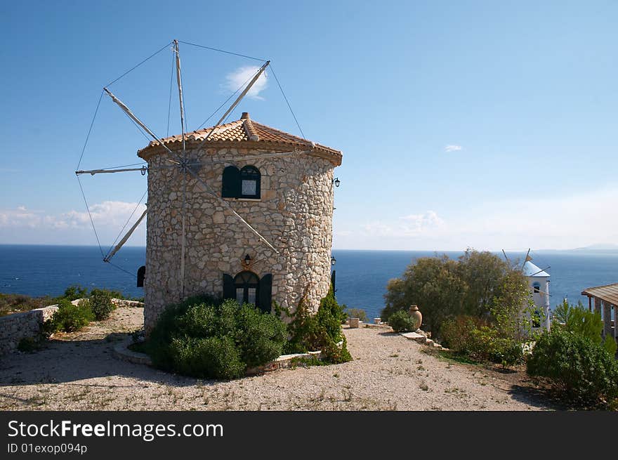 Windmills on hill over sea