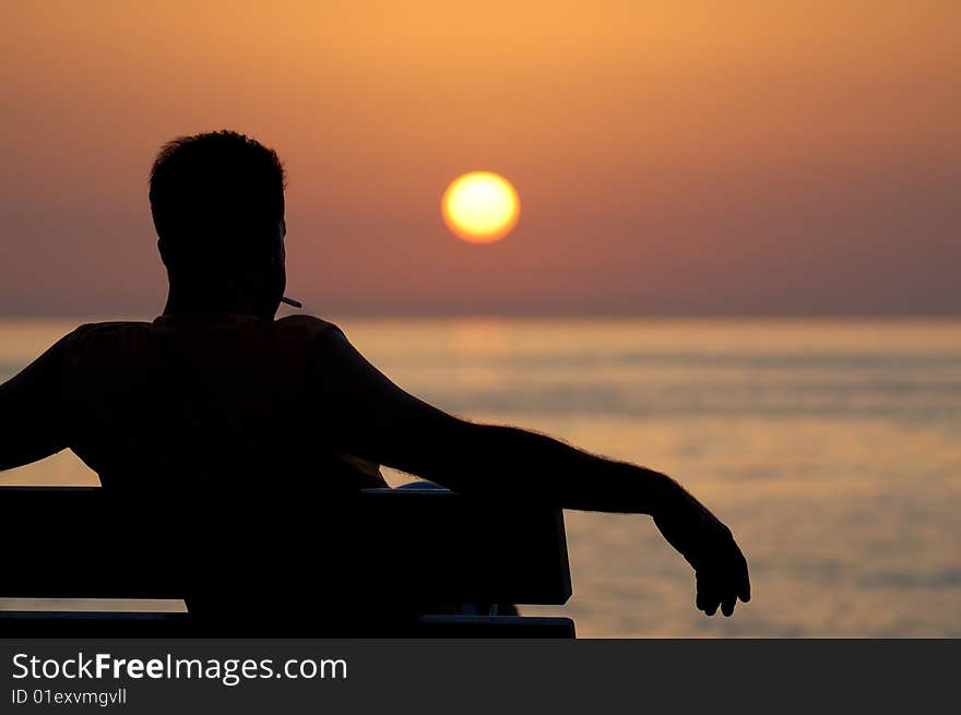 Male sitting on bench and relaxing. Male sitting on bench and relaxing