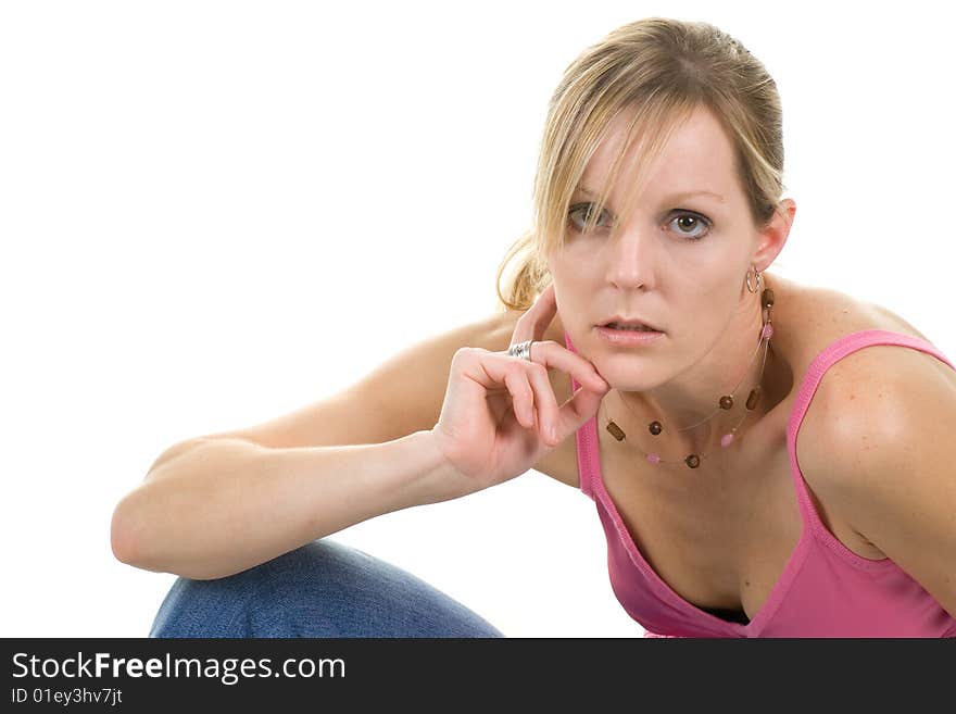 Casually posed blond woman wearing a pink tanktop. Casually posed blond woman wearing a pink tanktop