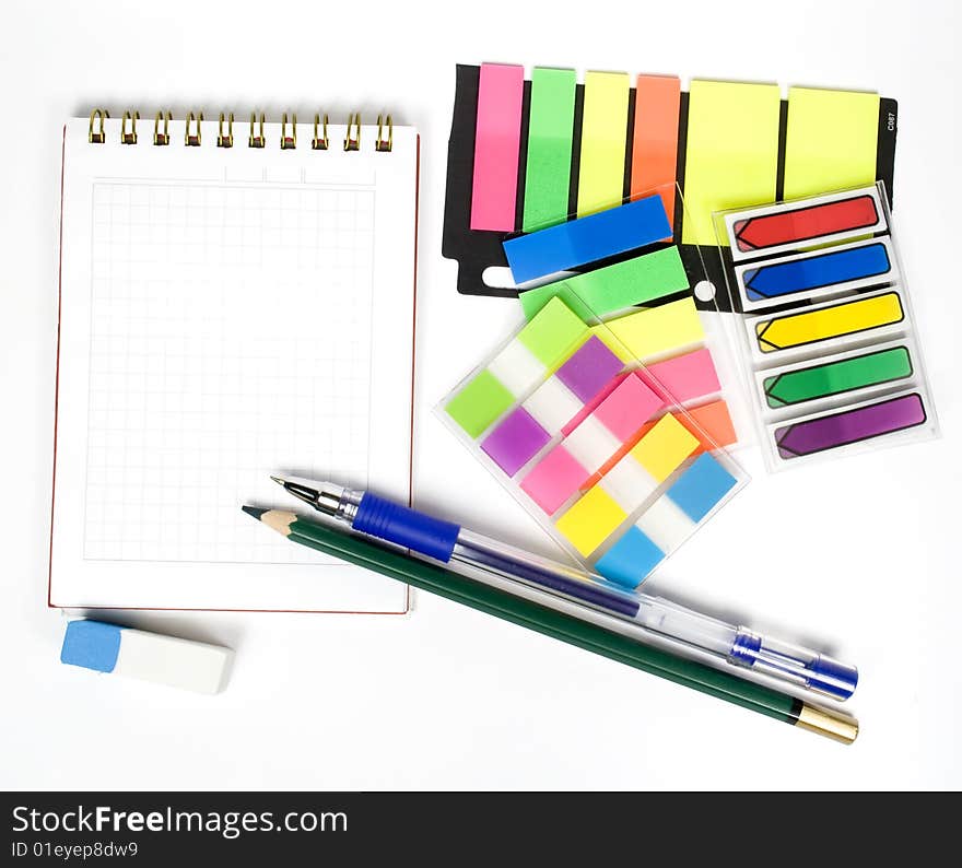 One open notebook with pen and set off colored stickers. One open notebook with pen and set off colored stickers