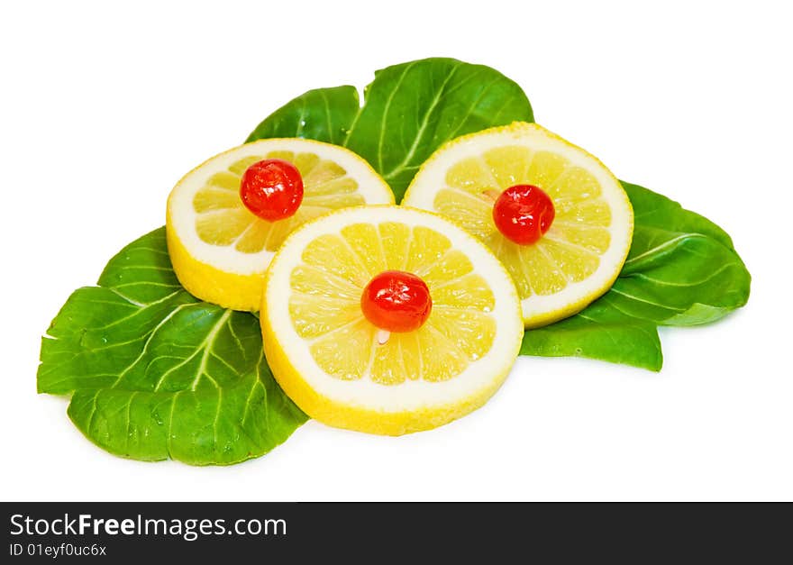 Sweet and sour - lemon slices and red cherries on green leaf. Isolated on white. Clipping path available at large size. Sweet and sour - lemon slices and red cherries on green leaf. Isolated on white. Clipping path available at large size.