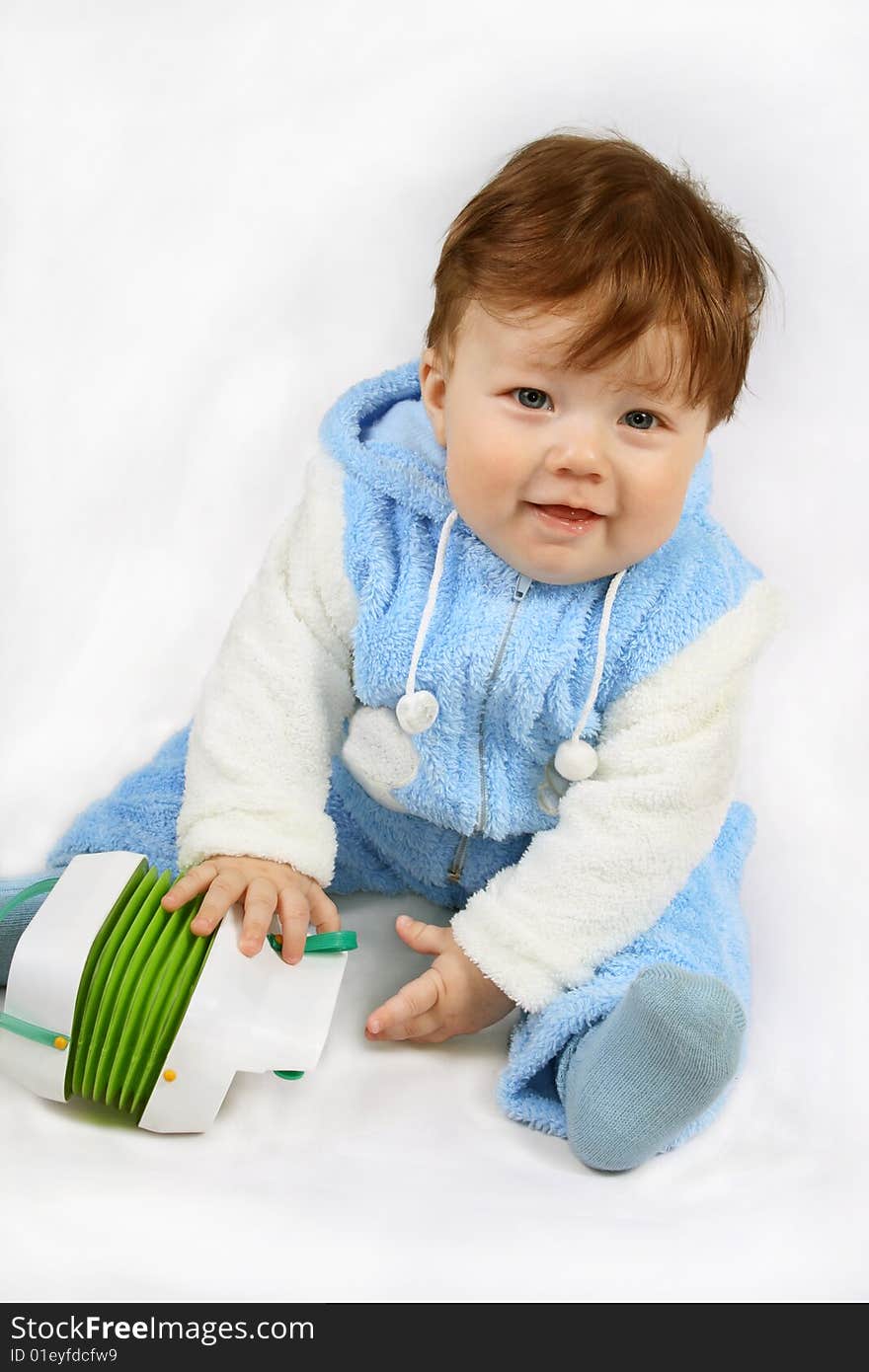 Happy small seven-month baby-boy It holds the toy. Isolated on white. Happy small seven-month baby-boy It holds the toy. Isolated on white