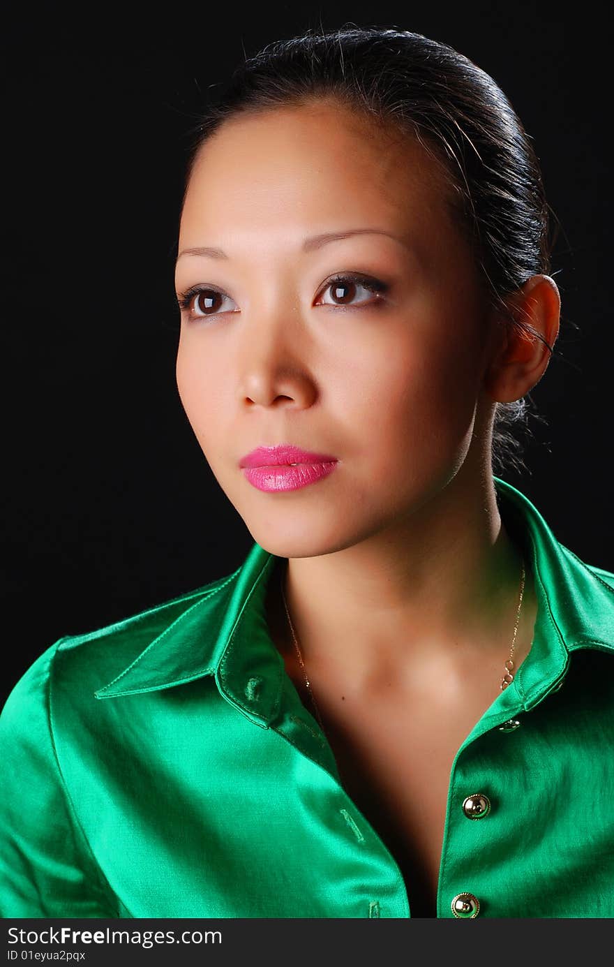 Portrait of a beautiful young woman in green shirt