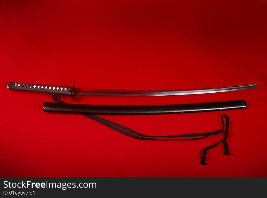 Japanese Sabre On Red Background