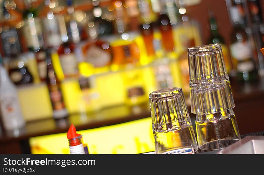 Illuminated bar counter with empty faceted glass. Illuminated bar counter with empty faceted glass