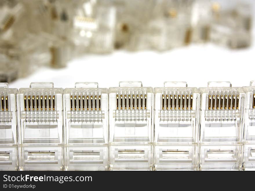 Plugs rj45 stay in a row. Heap of plugs on a background.