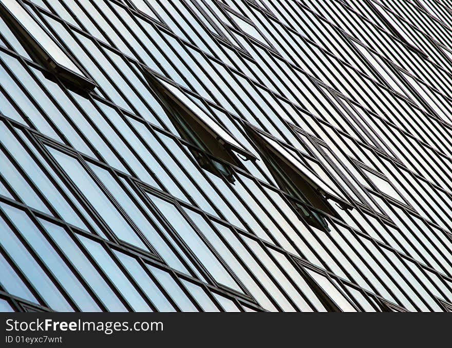 Close-up of glass fronted office block in city. Close-up of glass fronted office block in city