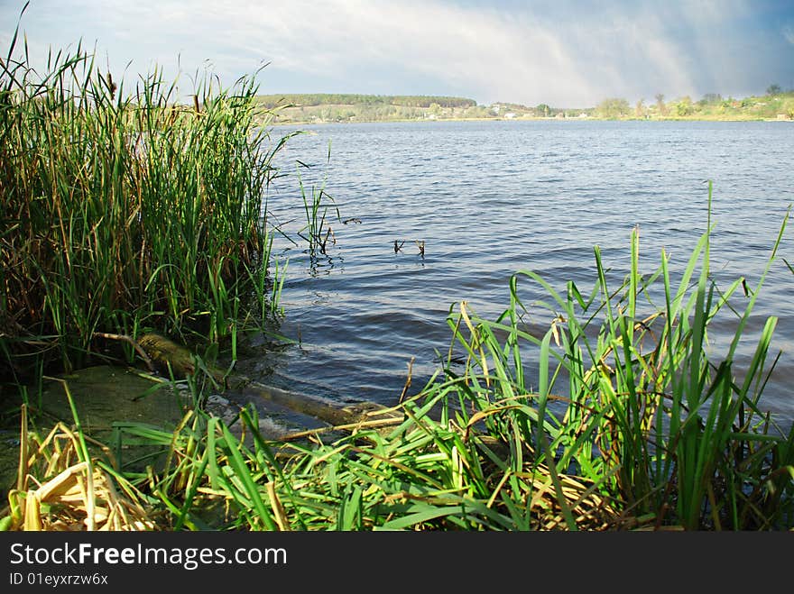 Landscape with river and blue cloudy sky. Landscape with river and blue cloudy sky